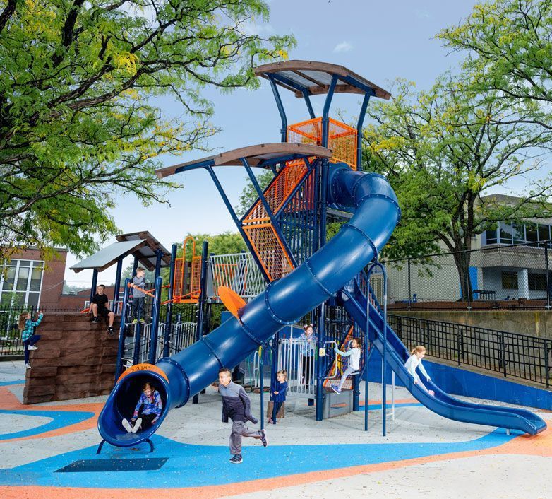 Commercial playground with tall blue tube slide