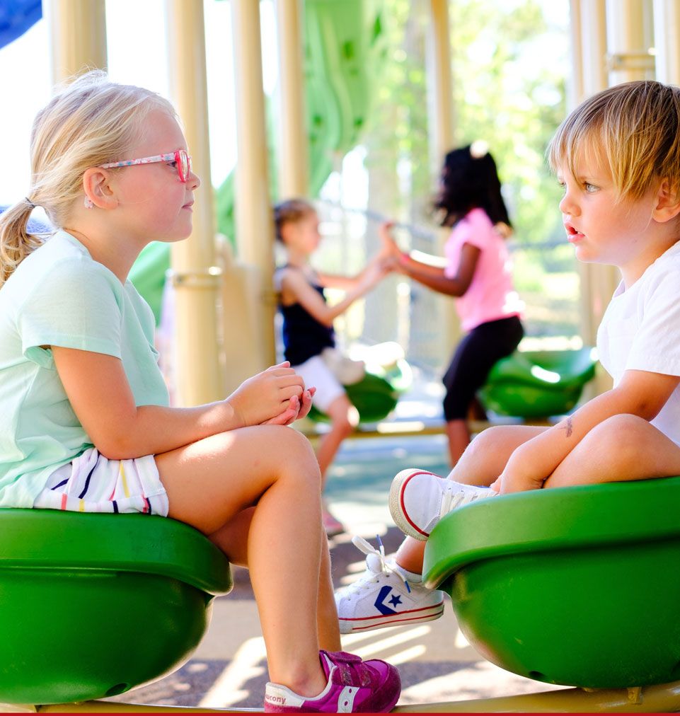 two kids talking on playground