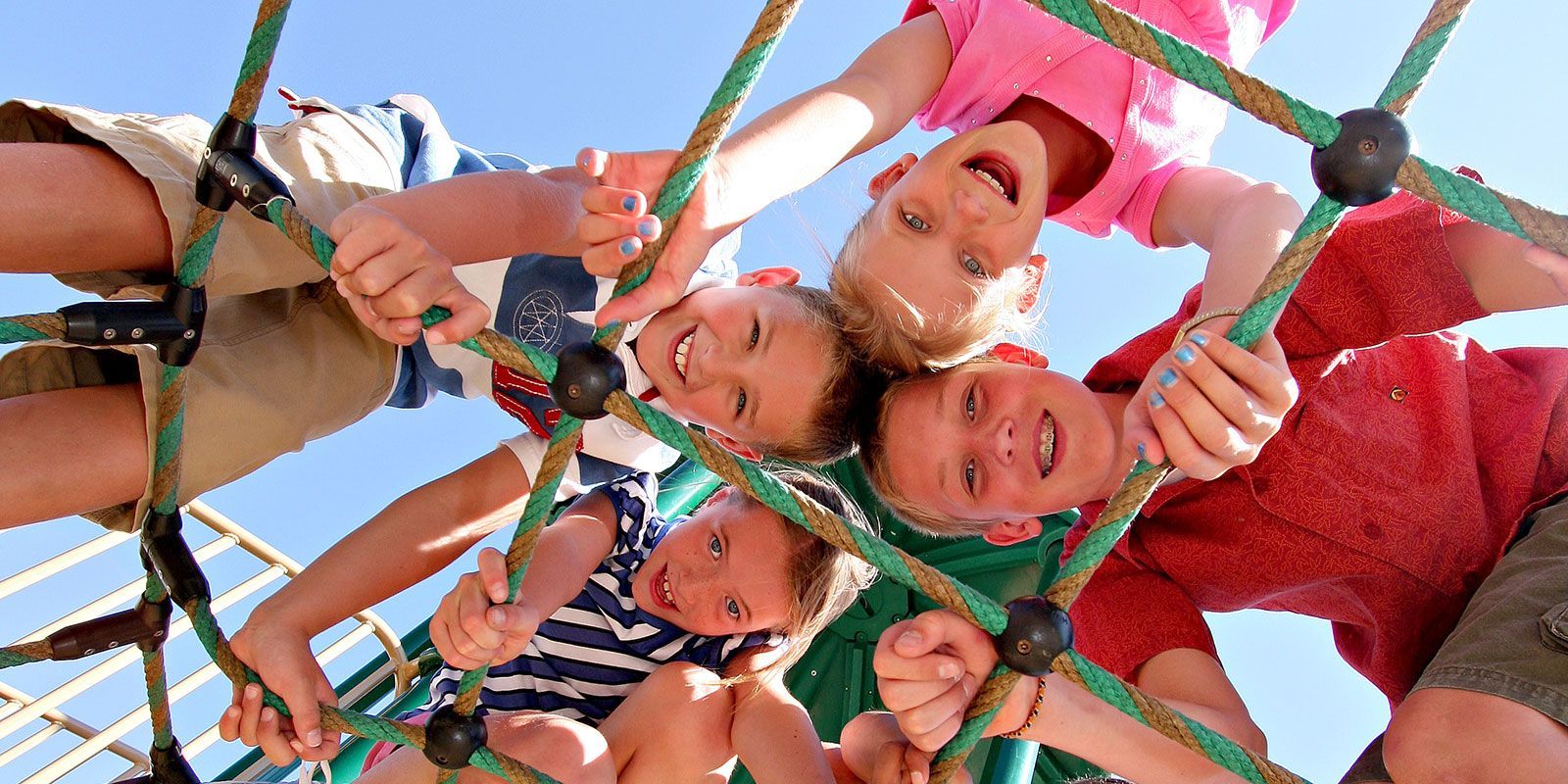 Children looking down and smiling