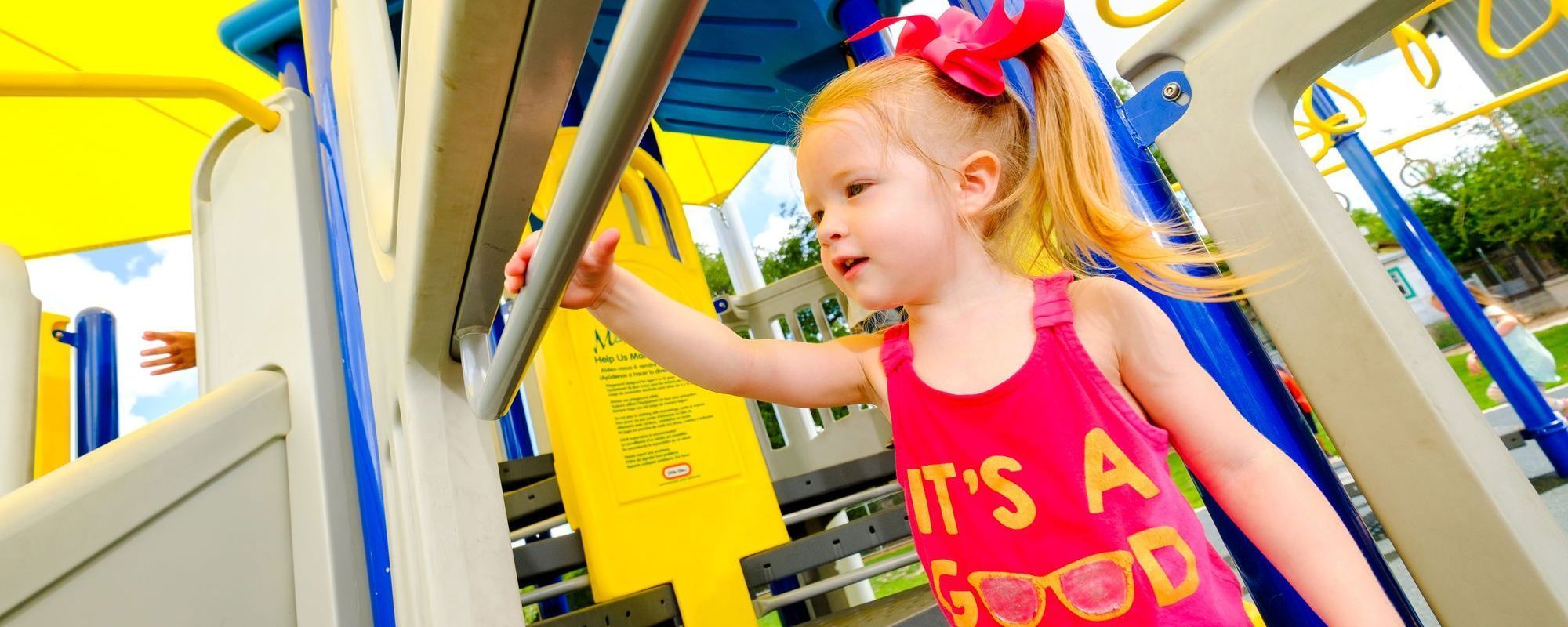 Little girl at top of slide before going down