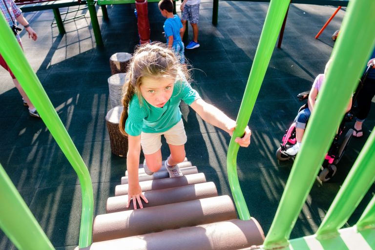 girl climbing up playground steps at billys playground