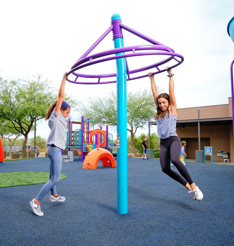 two girls swinging on playground overhead