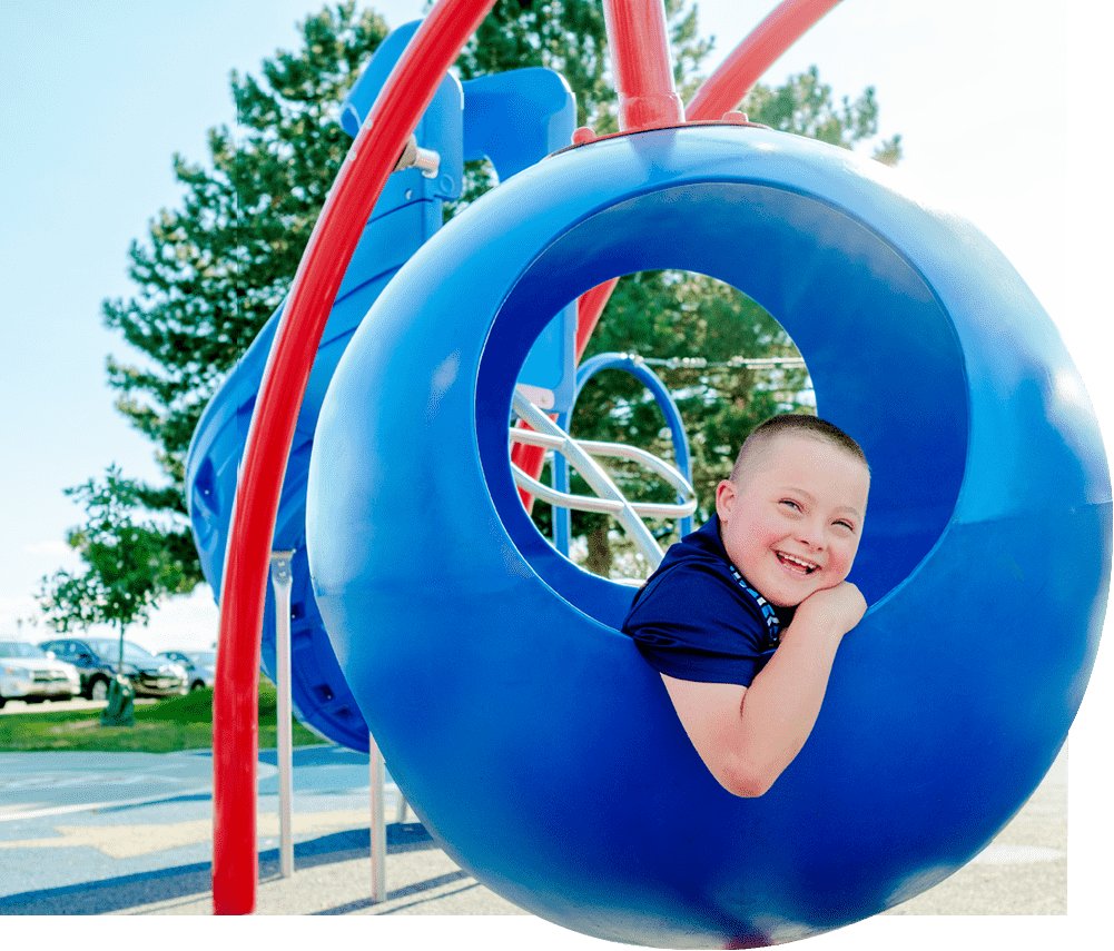 boy in sphere playground equipment